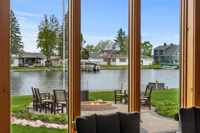 6801 Driftwood Cv, Saint Helen, MI 48656 - view of patio featuring an outdoor fire pit, a residential view, and a water view