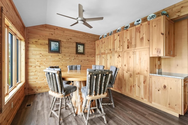 6801 Driftwood Cv, Saint Helen, MI 48656 - dining area with ceiling fan, vaulted ceiling, wooden walls, and dark wood-type flooring