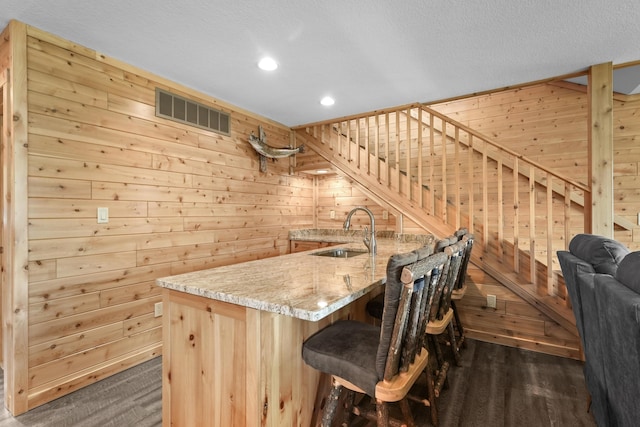 6801 Driftwood Cv, Saint Helen, MI 48656 - indoor wet bar with wood walls, recessed lighting, and dark wood-style flooring