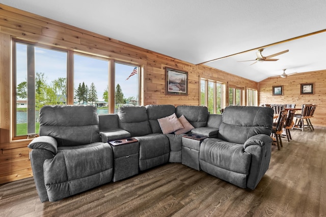 6801 Driftwood Cv, Saint Helen, MI 48656 - living room featuring wooden walls, healthy amount of natural light, dark wood finished floors, a ceiling fan, and vaulted ceiling