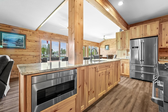 6801 Driftwood Cv, Saint Helen, MI 48656 - kitchen featuring appliances with stainless steel finishes, a ceiling fan, light brown cabinets, open floor plan, and a sink