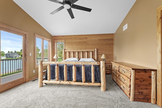 6801 Driftwood Cv, Saint Helen, MI 48656 - carpeted bedroom with vaulted ceiling, access to exterior, wood walls, a water view, and a ceiling fan