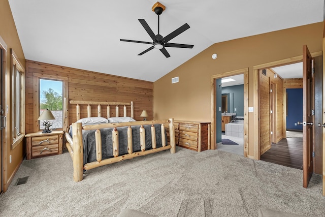 6801 Driftwood Cv, Saint Helen, MI 48656 - carpeted bedroom with vaulted ceiling, wooden walls, ensuite bathroom, and ceiling fan