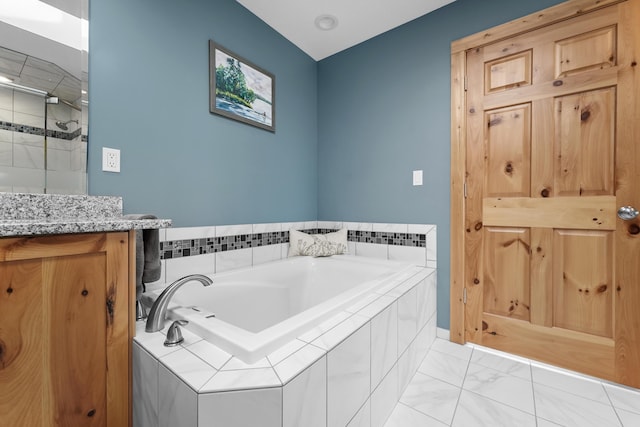 6801 Driftwood Cv, Saint Helen, MI 48656 - full bathroom with a garden tub, a stall shower, vanity, and marble look tiles