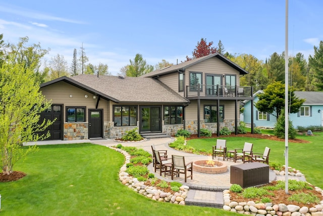 6801 Driftwood Cv, Saint Helen, MI 48656 - back of property featuring a fire pit, a balcony, a lawn, and stone siding