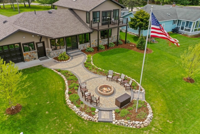 6801 Driftwood Cv, Saint Helen, MI 48656 - back of property with an outdoor fire pit, stone siding, a yard, and a shingled roof
