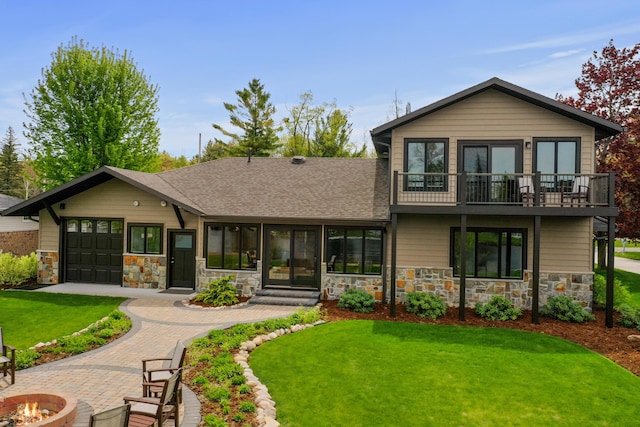 6801 Driftwood Cv, Saint Helen, MI 48656 - view of front facade with a fire pit, a balcony, stone siding, and a front yard
