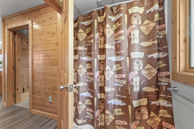6801 Driftwood Cv, Saint Helen, MI 48656 - bathroom featuring wooden walls and a shower with shower curtain