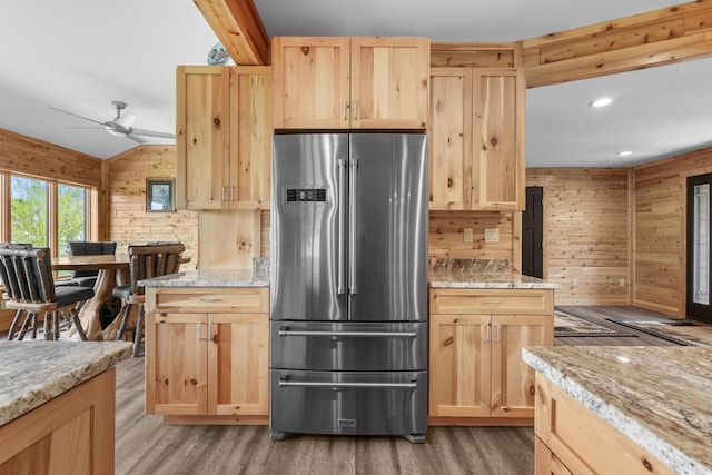 6801 Driftwood Cv, Saint Helen, MI 48656 - kitchen with high end fridge, light brown cabinetry, wooden walls, light wood-style floors, and a ceiling fan