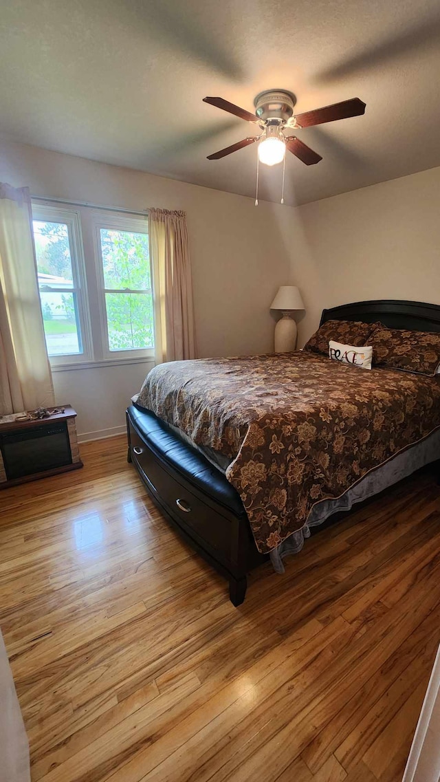 8619A Iowa St, Oscoda, MI 48750 - bedroom featuring wood finished floors, ceiling fan, and baseboards