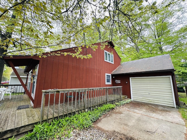 205 Beechwood Ave, Houghton Lake, MI 48629 - view of property exterior featuring an attached garage, concrete driveway, and a wooden deck