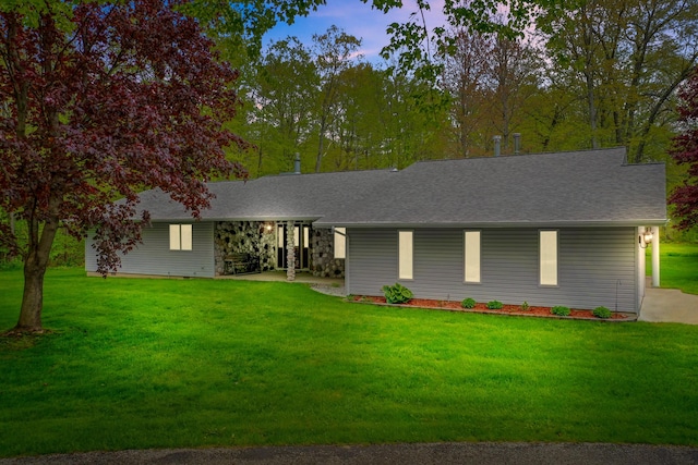 4285 Tower Hill Rd, Houghton Lake, MI 48629 - view of front of property featuring a front lawn and a shingled roof