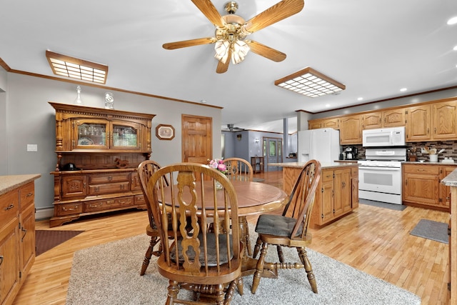 4285 Tower Hill Rd, Houghton Lake, MI 48629 - dining area with ceiling fan, light wood-style flooring, crown molding, recessed lighting, and a baseboard heating unit