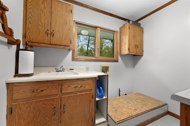 4285 Tower Hill Rd, Houghton Lake, MI 48629 - laundry room featuring ornamental molding, cabinet space, washer hookup, and baseboards