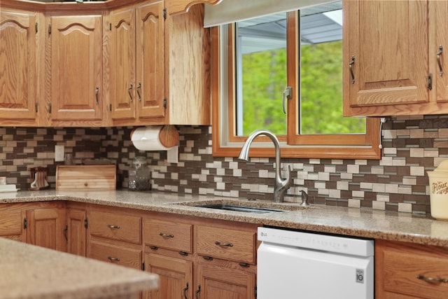 4285 Tower Hill Rd, Houghton Lake, MI 48629 - kitchen featuring white dishwasher, a sink, and decorative backsplash