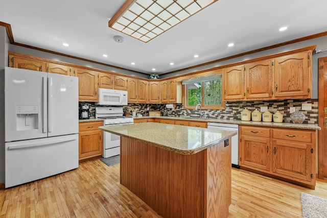 4285 Tower Hill Rd, Houghton Lake, MI 48629 - kitchen featuring white appliances, a sink, crown molding, light wood-style flooring, and decorative backsplash