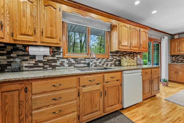 4285 Tower Hill Rd, Houghton Lake, MI 48629 - kitchen with dishwasher, a sink, tasteful backsplash, light wood-style floors, and ornamental molding