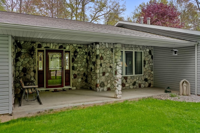4285 Tower Hill Rd, Houghton Lake, MI 48629 - property entrance featuring stone siding, covered porch, and roof with shingles