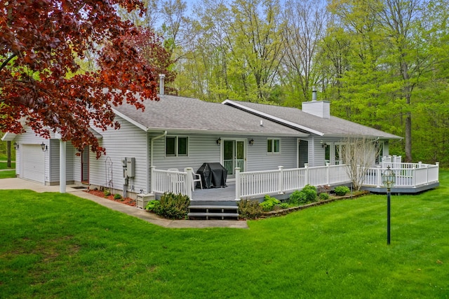 4285 Tower Hill Rd, Houghton Lake, MI 48629 - back of property featuring a chimney, a lawn, a wooden deck, and roof with shingles