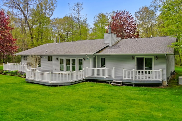 4285 Tower Hill Rd, Houghton Lake, MI 48629 - rear view of house featuring a chimney, a shingled roof, a yard, and a wooden deck