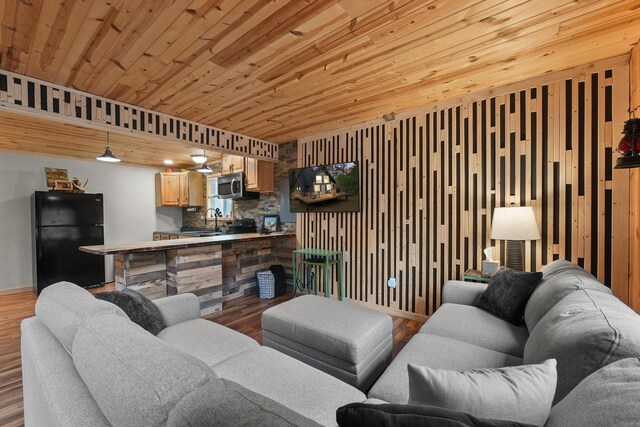 7028 Merrio Rd, Grayling, MI 49738 - living area featuring wood finished floors, wooden ceiling, and baseboards