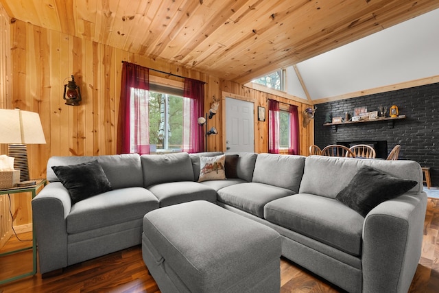 7028 Merrio Rd, Grayling, MI 49738 - living area with wood walls, lofted ceiling, a brick fireplace, wood finished floors, and wood ceiling
