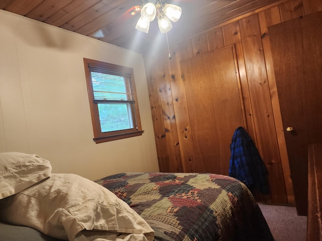 7305 Chain Lake Dr, South Branch, MI 48761 - bedroom featuring carpet flooring and wood walls