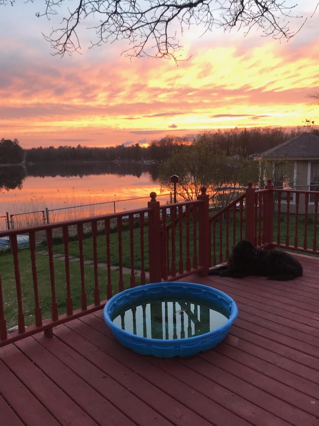 7305 Chain Lake Dr, South Branch, MI 48761 - deck at dusk featuring a water view