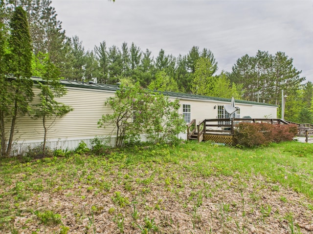 730 SE Cool Rd, Kalkaska, MI 49646 - back of house featuring a wooden deck