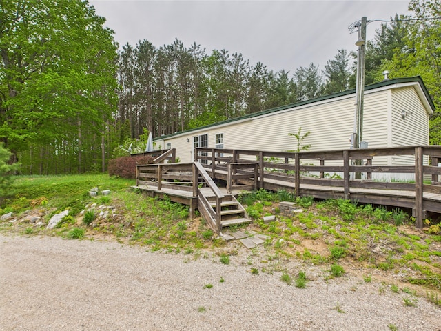 730 SE Cool Rd, Kalkaska, MI 49646 - view of side of property featuring a deck