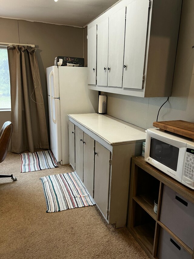 10181 E Carter Lake Rd, Saint Helen, MI 48656 - kitchen featuring white appliances, light carpet, light countertops, and white cabinets