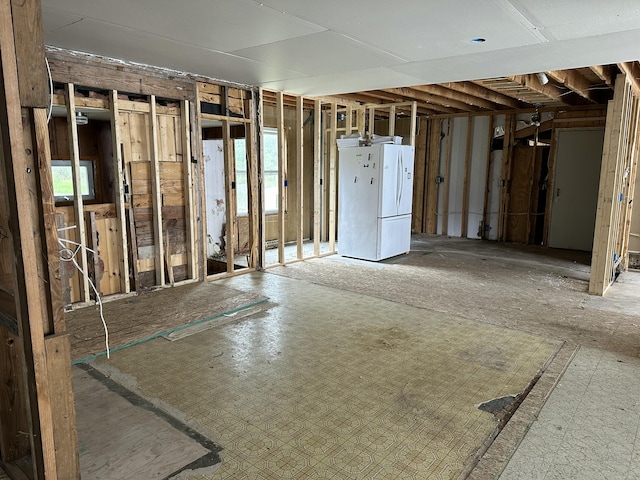 2883 M-18, Roscommon, MI 48653 - basement featuring freestanding refrigerator and plenty of natural light