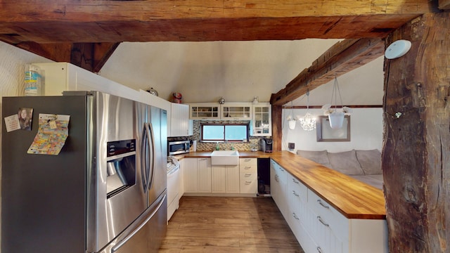 605 Cedar Ave, Houghton Lake, MI 48629 - kitchen featuring appliances with stainless steel finishes, butcher block counters, wood finished floors, and white cabinetry