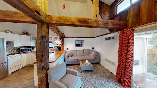 605 Cedar Ave, Houghton Lake, MI 48629 - living area featuring light wood-type flooring and beam ceiling