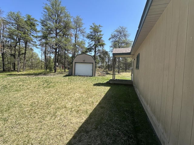 269 Dixson Dr, Grayling, MI 49738 - view of green lawn featuring an outdoor structure and a garage
