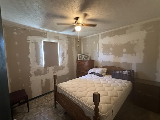 269 Dixson Dr, Grayling, MI 49738 - bedroom with tile patterned floors, a textured ceiling, and a ceiling fan