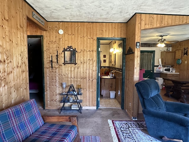269 Dixson Dr, Grayling, MI 49738 - living area featuring wooden walls and ceiling fan