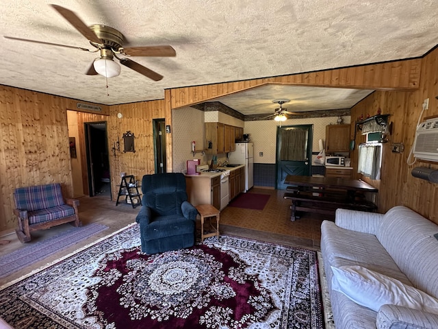269 Dixson Dr, Grayling, MI 49738 - living room featuring a ceiling fan, a textured ceiling, and wood walls