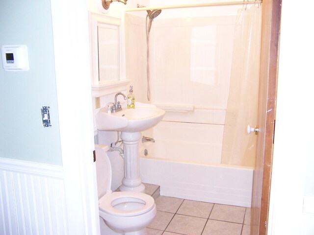 8778 N Townline Rd, Roscommon, MI 48653 - full bath with toilet, tile patterned flooring, shower / bath combo, and wainscoting
