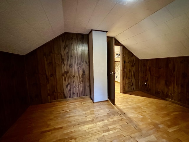 370 W Park Dr, Grayling, MI 49738 - additional living space featuring wooden walls, vaulted ceiling, and light wood finished floors
