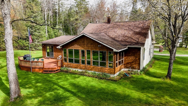 370 W Park Dr, Grayling, MI 49738 - rear view of property with a shingled roof, a lawn, a deck, and a chimney