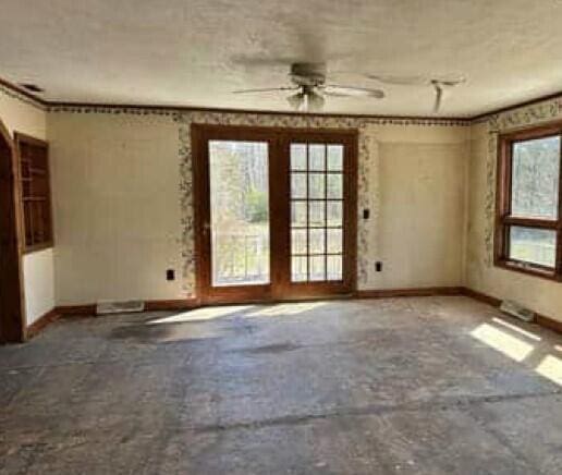 29098 W H 40, Moran, MI 49760 - spare room featuring baseboards and ceiling fan