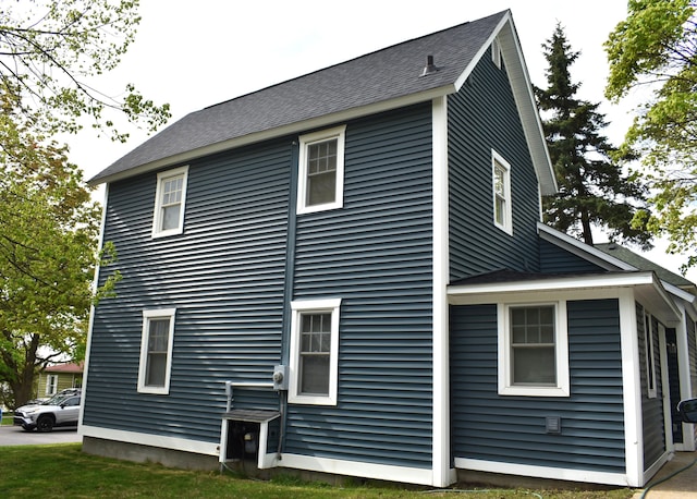 1131 Emmet St, Petoskey, MI 49770 - view of side of home featuring a shingled roof