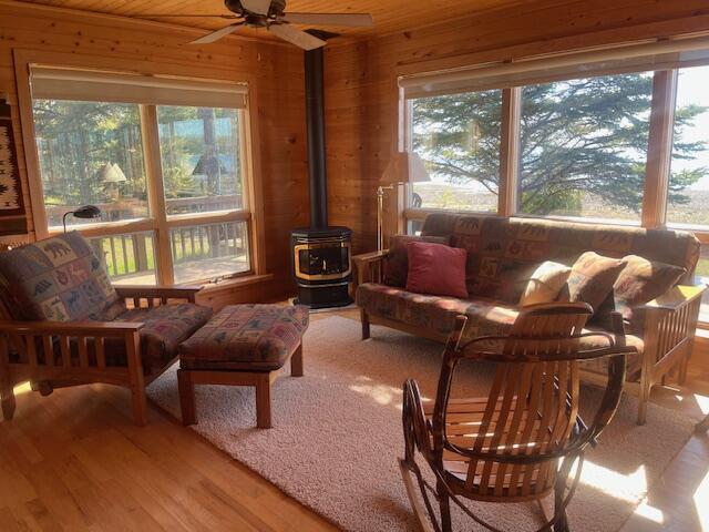 3199 S Lake Shore Dr, Bois Blanc, MI 49775 - sunroom with a wood stove and plenty of natural light