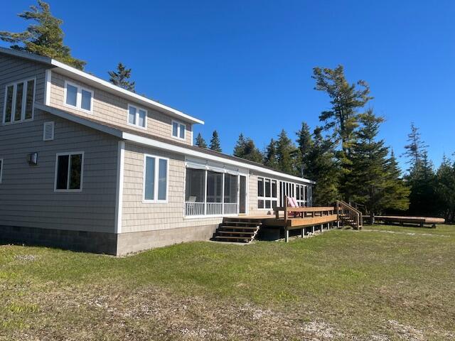 3199 S Lake Shore Dr, Bois Blanc, MI 49775 - back of house featuring a deck and a yard
