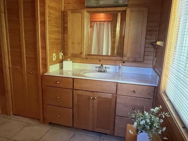 3199 S Lake Shore Dr, Bois Blanc, MI 49775 - bathroom with vanity, wooden walls, and tile patterned floors