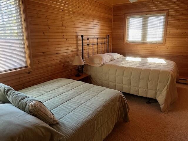 3199 S Lake Shore Dr, Bois Blanc, MI 49775 - bedroom featuring wooden walls and carpet