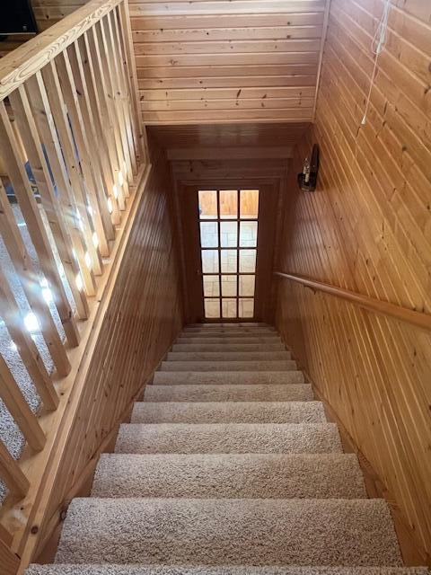 3199 S Lake Shore Dr, Bois Blanc, MI 49775 - stairs featuring wood walls and lofted ceiling