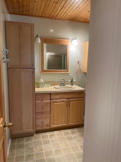 3199 S Lake Shore Dr, Bois Blanc, MI 49775 - bathroom with wood ceiling, vanity, and a shower