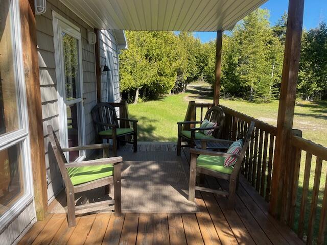 3199 S Lake Shore Dr, Bois Blanc, MI 49775 - wooden terrace with a lawn
